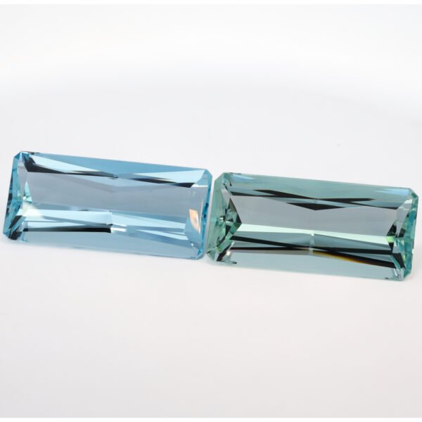 Museum-quality flawless blue-green aquamarine pair from Brazil, investment-grade 245ct beryl gemstones. Perfect Shine Global.