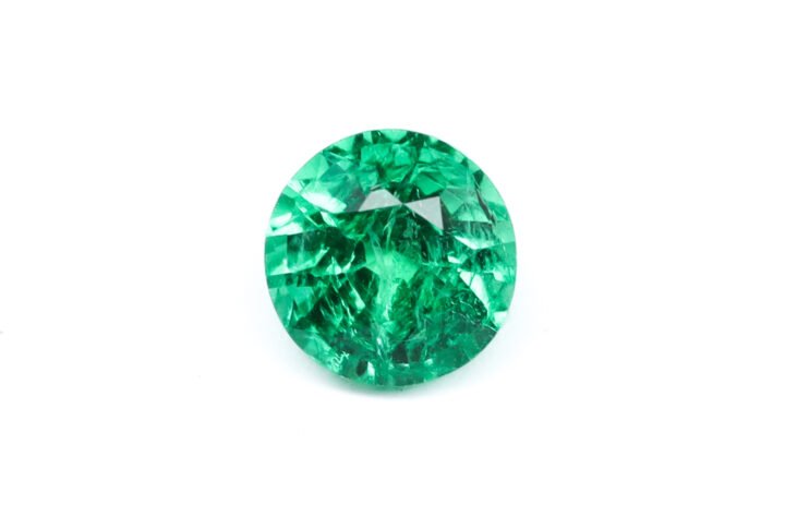 "1.71 carat natural Zambian emerald, vibrant green color, large round brilliant cut, 7.8mm diameter."